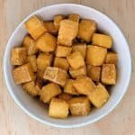 A delicious baked tofu recipe presented in a white bowl.