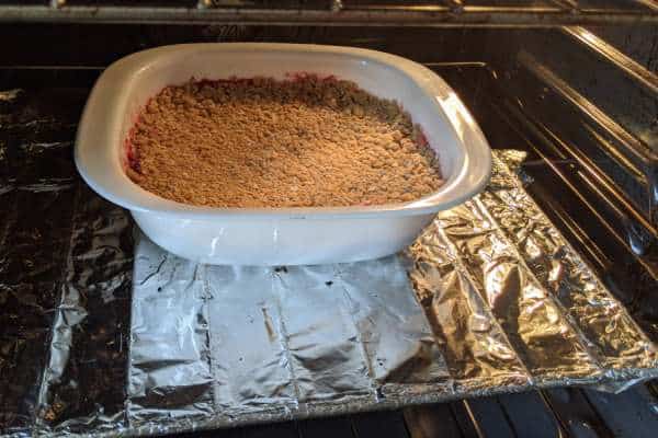A tasty apple cranberry crumble cooking in the oven.