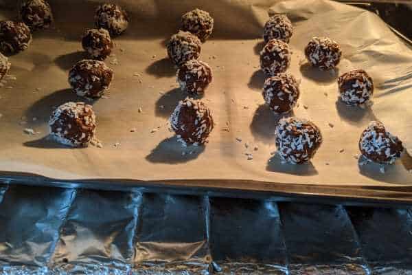 Cooking choco-coco-rum balls in the oven.