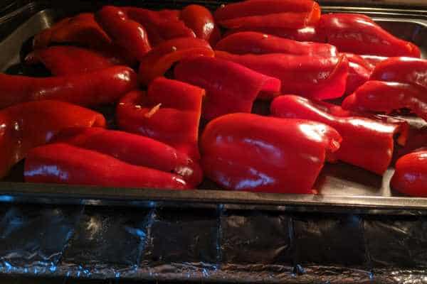 Raw red pepper disposed on a cooking sheet.