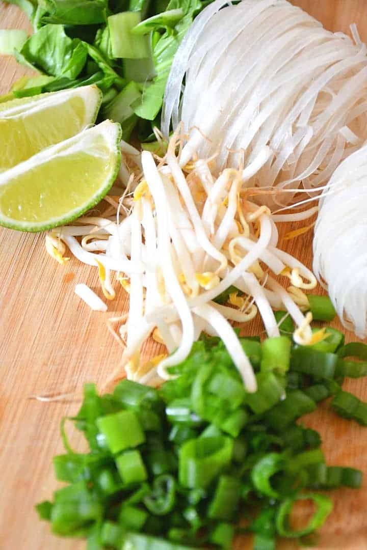 Lime wedges, green chopped onions, bean sprouts and dry rice noodles for the low sodium vegan pho.