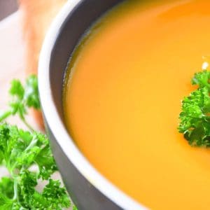 The presentation of the low sodium butternut squash soup with fresh parsley.