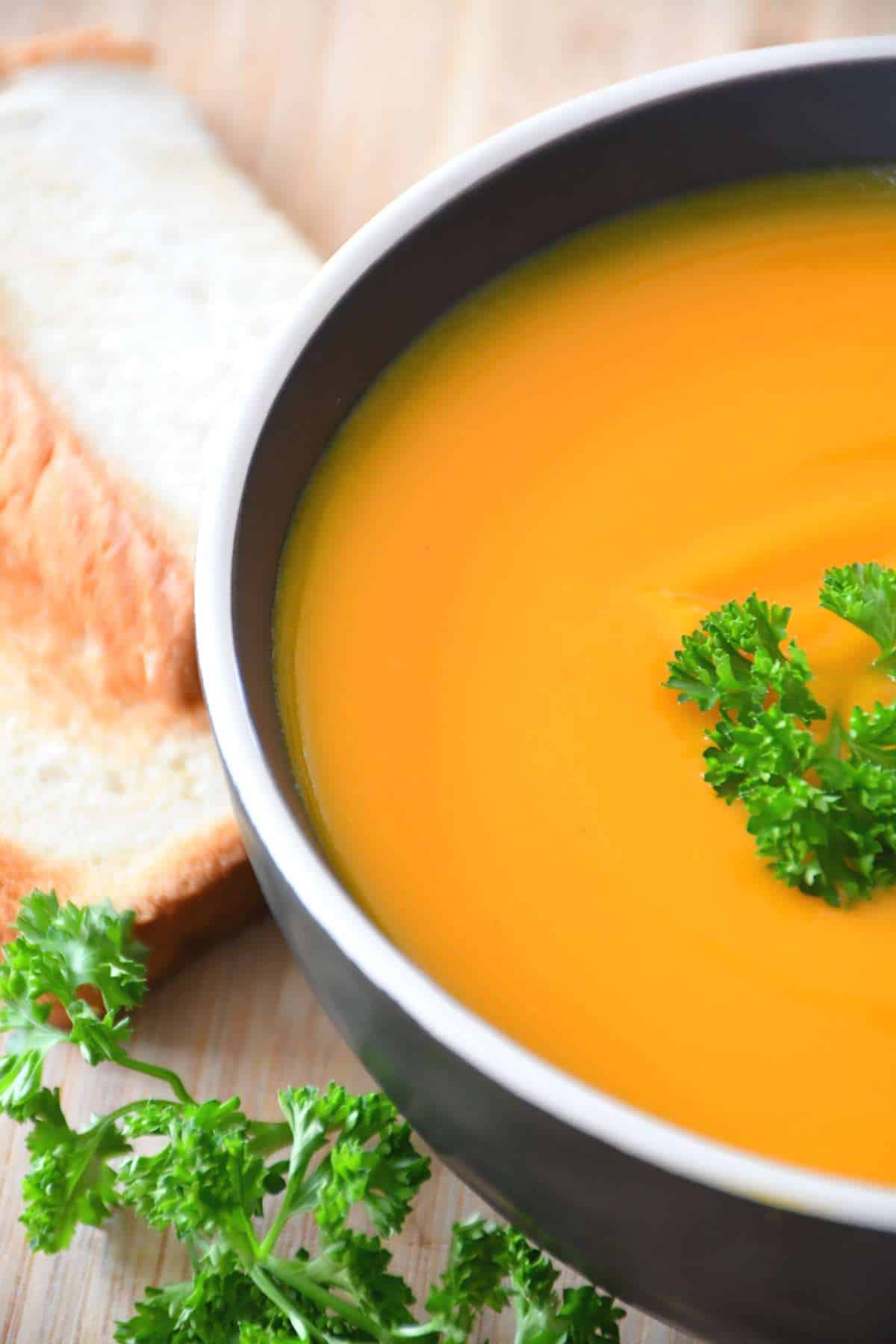 A close-up on the low sodium butternut squash soup with fresh parsley.