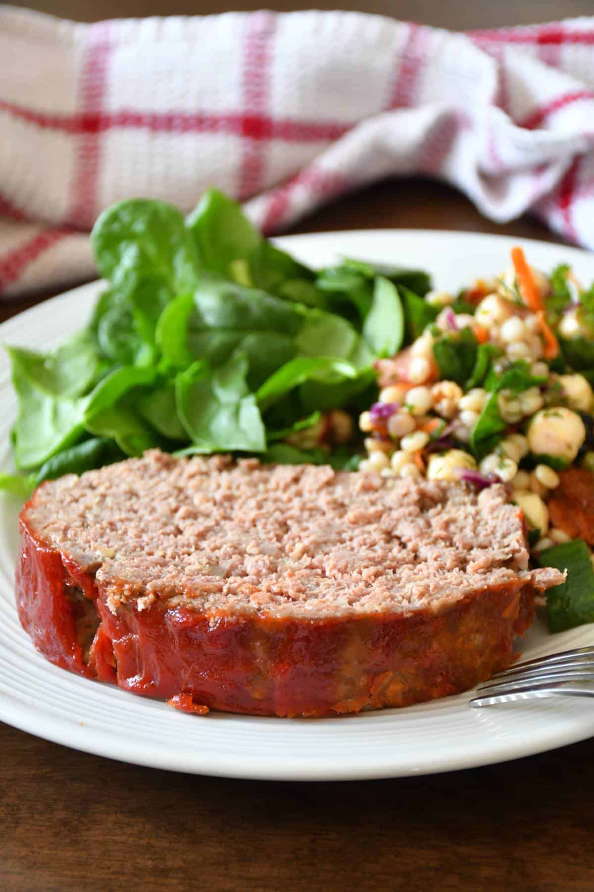 A delicious low sodium meatloaf served with greens and couscous salad.