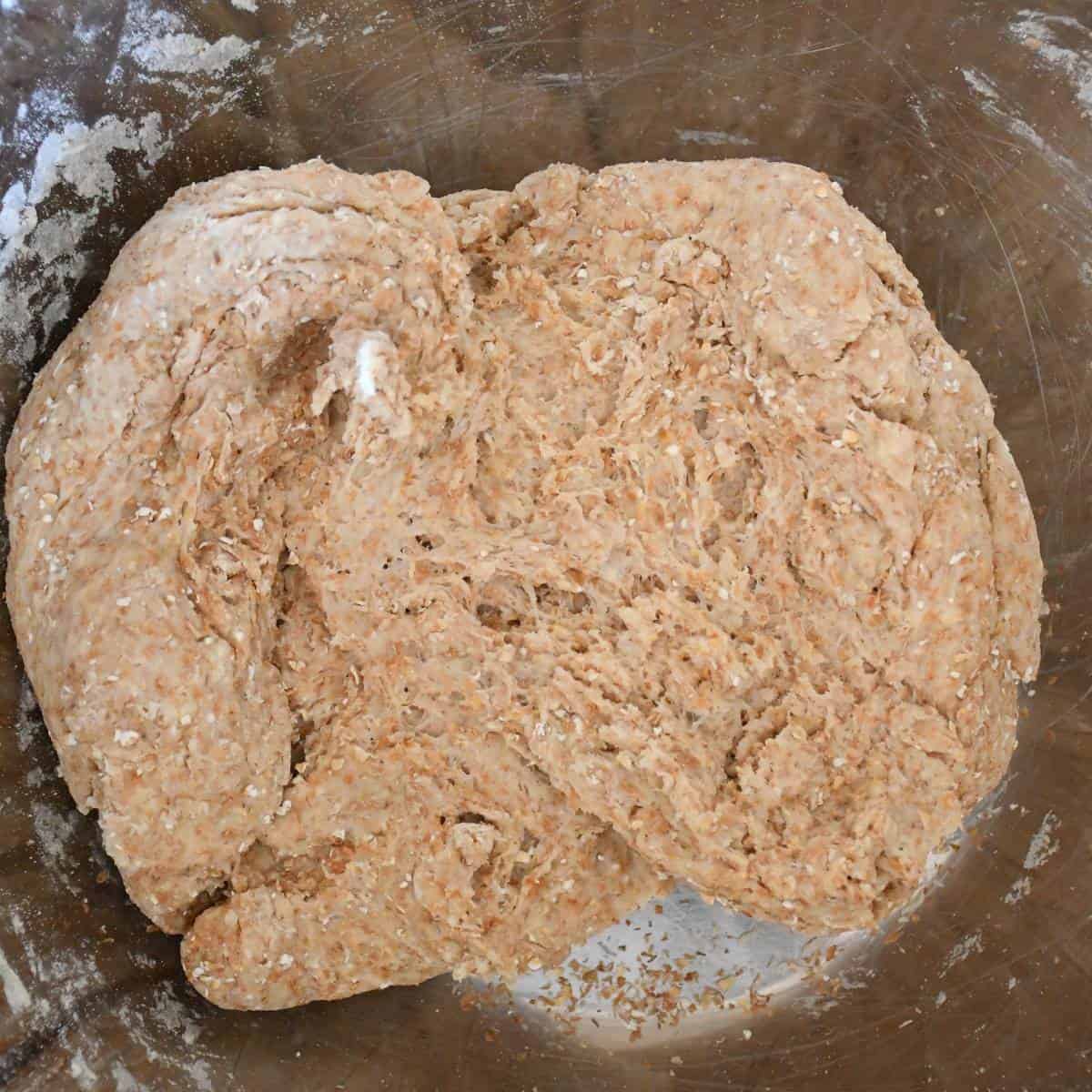 Low sodium whole wheat pizza dough mixed in a stainless bowl.