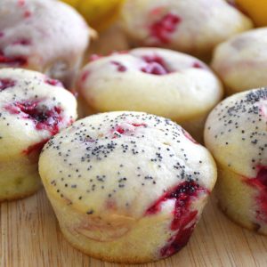 Delicious and fresh raspberry and lemon muffin featured on a bamboo board.